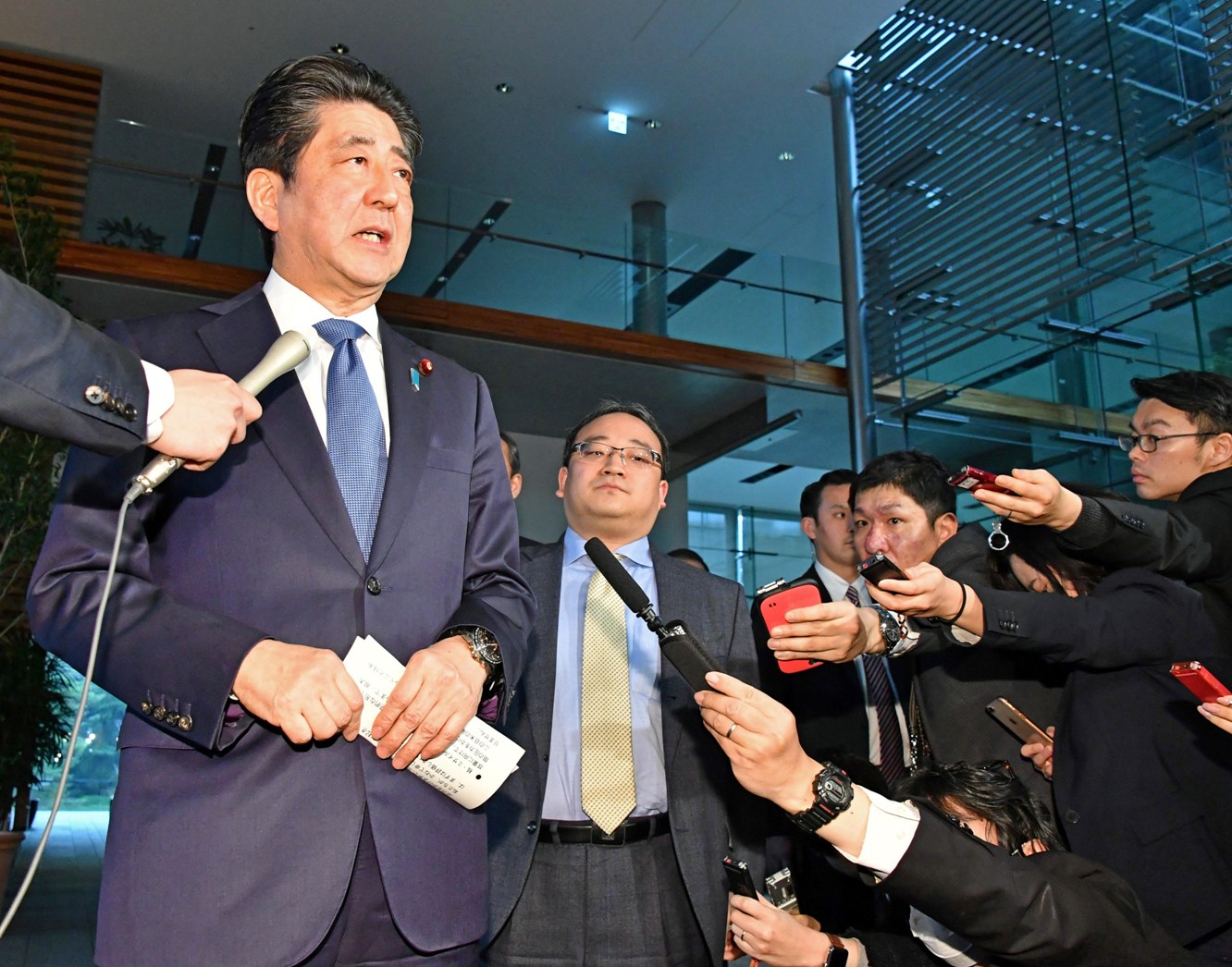 Prime Minister Shinzo Abe talks with members of the press